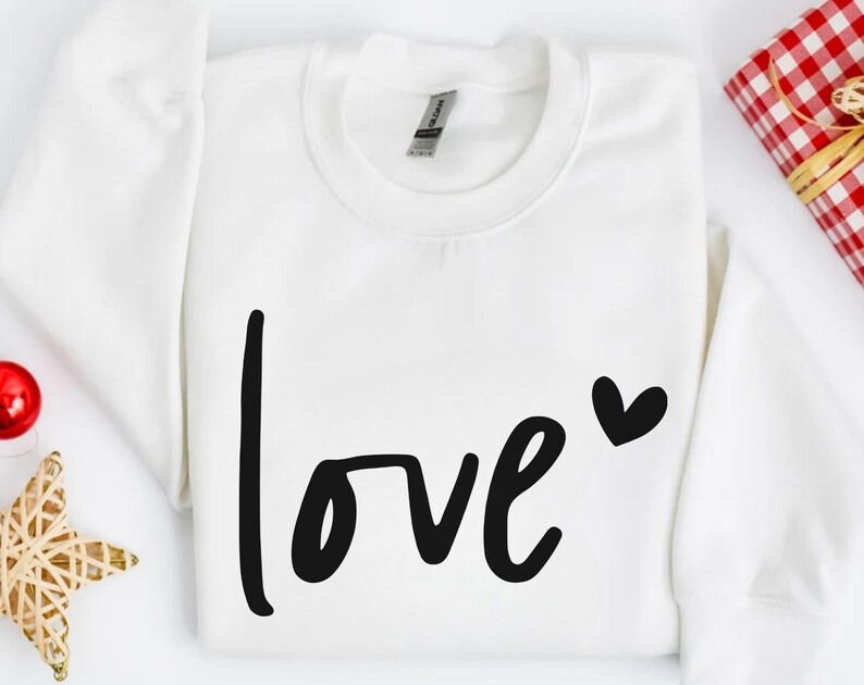 a white shirt with the word love written on it