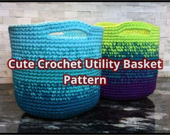 May include: Two crocheted utility baskets, one blue and green ombre and the other purple and green ombre.  "Cute Crochet Utility Basket Pattern" is written in red text on the image.
