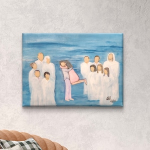 May include: An abstract painting on canvas shows figures in white robes, with a couple embracing in the center against a light blue backdrop. The artwork is signed in the lower right corner. The painting evokes a sense of serenity.