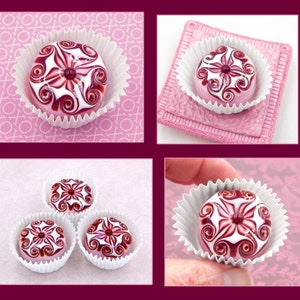May include: Four white cupcake liners with pink and white swirl designs on top. The swirls are in a red and white color scheme. The cupcakes are arranged in a square pattern.