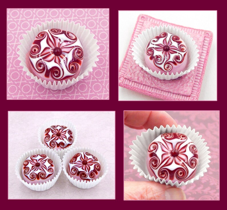 May include: Four white cupcake liners with pink and white swirl designs on top. The swirls are in a red and white color scheme. The cupcakes are arranged in a square pattern.