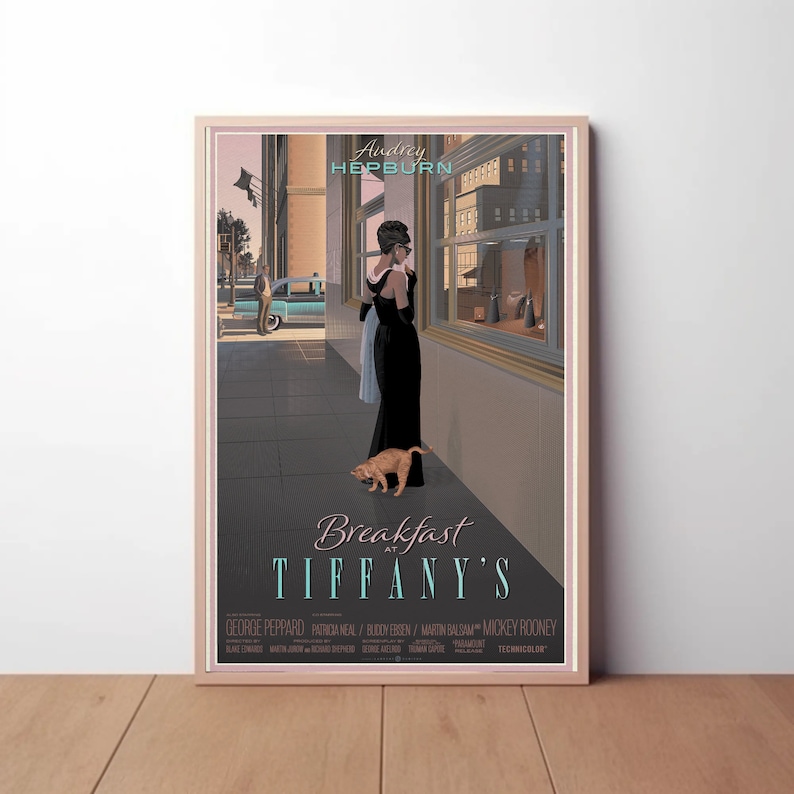 May include: A vintage movie poster for the film "Breakfast at Tiffany's" featuring Audrey Hepburn in a black dress and a small orange cat. The poster has a gray background with a cityscape in the background.