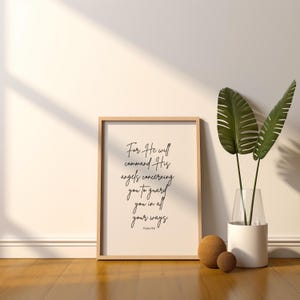 May include: A framed print with a white background and black text. The text reads "For He will command His angels concerning you to guard you in all your ways. Psalm 91:11".