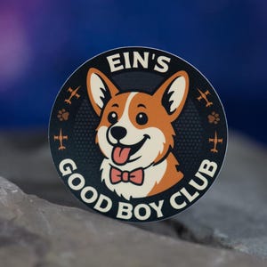 May include: A round sticker featuring a cartoon corgi dog with a red bow tie and its tongue sticking out. The sticker has the text "EIN'S GOOD BOY CLUB" in white lettering around the dog's image. The background is a gradient of blue and purple.