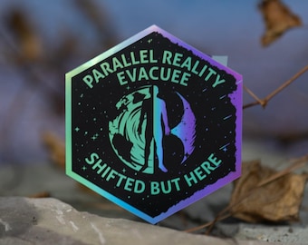 May include: A hexagonal sticker with the text "PARALLEL REALITY EVACUEE SHIFTED BUT HERE". The sticker features a person silhouette and a swirling design in shades of blue, green, and purple. The background is a blurred blue.