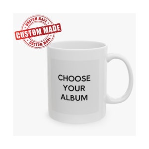 May include: White ceramic mug with black text overlay that reads "CHOOSE YOUR ALBUM". The mug has a red custom made stamp in the top left corner.