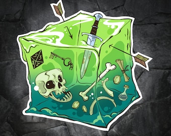 May include: A green, translucent, cube-shaped container filled with various objects, including a sword, a skull, bones, a key, and a potion bottle. The container has a dice symbol on one side, reading "8/2 5/3".