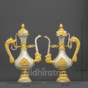May include: Two ornate silver and gold decorative vases, each 24 cm wide and 41.5 cm tall. The vases feature intricate dragon-shaped handles, detailed carvings, and decorative tops. The design includes a hammered silver body and gold accents.