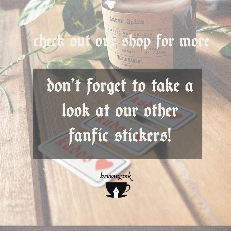 May include: Three red heart stickers with the word "kudos" written in white on each sticker. The stickers are on a wooden surface with a candle and greenery in the background. The text "don't forget to take a look at our other fanfic stickers!" is written in black on a white background.