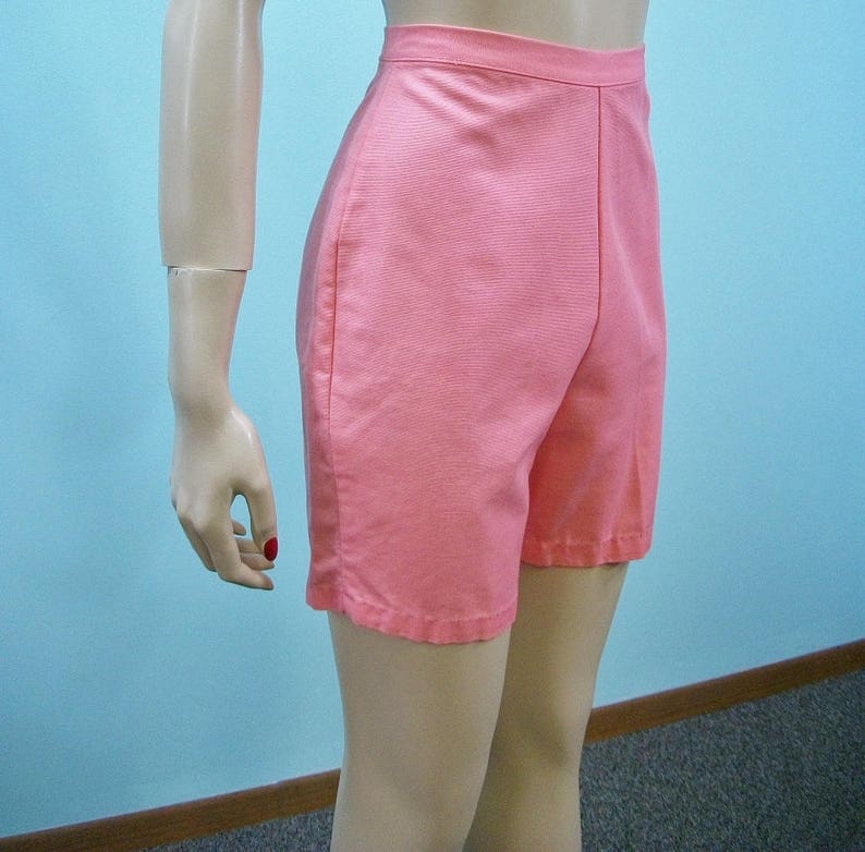 May include: A pair of pink high-waisted shorts with a straight leg.