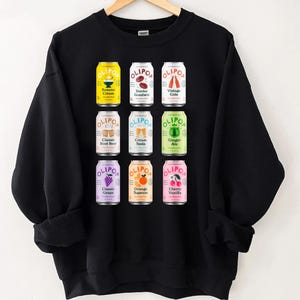 Olipop Cans Shirt | Retro Soda Graphic Tee | Vintage Beverage T-Shirt | Fun Soda Lover Shirt | Trendy Summer Graphic Tee | Olipop Fan Gift