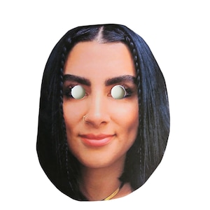 May include: A paper face mask featuring a photo of a woman with long black hair. The mask has eye holes and a nose hole.