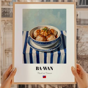 Puede incluir: Una impresión enmarcada que presenta una naturaleza muerta de Ba-Wan, un plato taiwanés. La obra de arte representa un cuenco de albóndigas en una salsa sabrosa, sobre un mantel a rayas azules y blancas. La impresión incluye el texto "BA-WAN" y "Made in Taiwan".