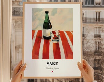 May include: A framed print featuring a still life of a sake bottle and a glass on a red and white striped surface. The bottle is green with a white label. The word "SAKE" is printed below the image, with "Made in Japan" underneath.