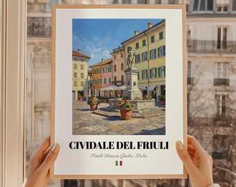 Puede incluir: Una impresión enmarcada de Civiale del Friuli, Italia, que presenta una vibrante pintura de paisaje urbano. La obra de arte representa edificios coloridos, una fuente y flores en macetas bajo un cielo azul brillante. La impresión incluye el nombre y la ubicación de la ciudad en texto.