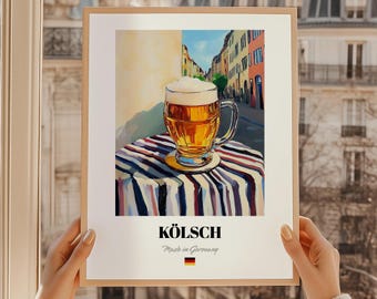 May include: A framed print featuring a glass of Kölsch beer with a foamy head, set on a striped tablecloth. The background depicts a European street scene. The print includes the word "KÖLSCH" and "Made in Germany".