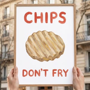 Könnte beinhalten: Ein gerahmter Druck mit den Worten "CHIPS DON'T FRY" in roter Aquarellschrift. Das Bild zeigt eine detaillierte Illustration eines geriffelten Kartoffelchips in Braun- und Beigetönen.