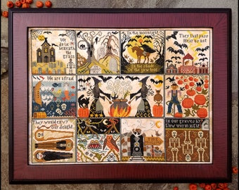 May include: A cross-stitch sampler with a Halloween theme. The sampler is divided into nine squares, each with a different scene. The scenes include a graveyard, a witch's cauldron, a scarecrow, and a pumpkin patch. The sampler is framed in a dark wood frame.