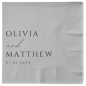 May include: A white paper napkin with black text that reads "Olivia and Matthew 07.01.2024".