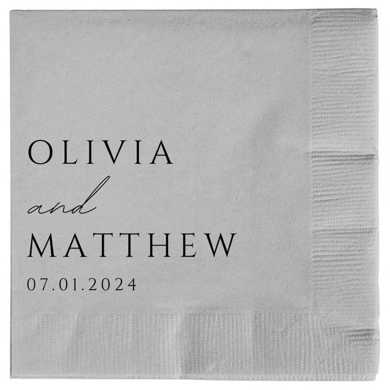 May include: A white paper napkin with black text that reads "Olivia and Matthew 07.01.2024".