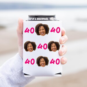 May include: White can cooler with a black top and the text "Part of a Multipack Only to" printed on the top. The cooler has a repeated pattern of a woman's face and the number "40" printed in pink.