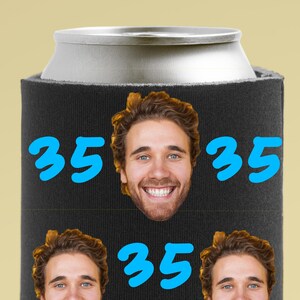 May include: Black neoprene can cooler with a blue number 35 printed on each side. The cooler has a photo of a person's face printed on the front.