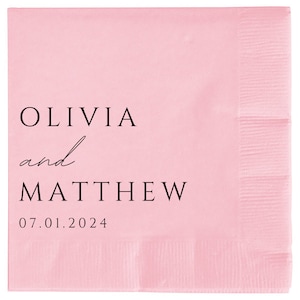May include: Pink paper napkin with black text that reads "Olivia and Matthew 07.01.2024".