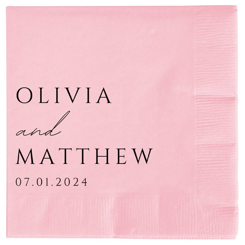 May include: Pink paper napkin with black text that reads "Olivia and Matthew 07.01.2024".