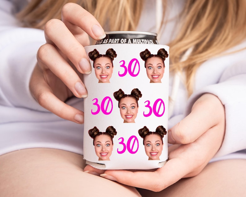 May include: White can cooler with a pink number 30 and multiple images of a woman with brown hair in pigtails. The can cooler has the text "Sold as part of a multipack".