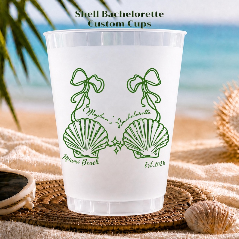 May include: A translucent white plastic cup featuring a green graphic of two seashells connected by ribbons. The text reads Meghan's Bachelorette, Miami Beach, and Est. 2026. The design includes small four-pointed star accents between the shells.