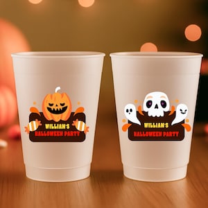 May include: Two white plastic cups with Halloween-themed designs. One cup features an orange jack-o'-lantern, and the other has a skull and ghosts. Both cups have the text "WILLIAM'S HALLOWEEN PARTY" on a brown banner.