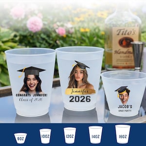 May include: Three frosted plastic cups featuring graduation-themed designs. Two large cups display photos of a person wearing a graduation cap with text reading "CONGRATS JENNIFER! Class of 2026" and "Jennifer 2026". A smaller cup shows a photo with "JACOB'S GRAD PARTY!"