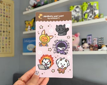 May include: A pink sticker sheet featuring cartoon animal characters in various costumes and expressions. The sheet includes a cat, a rabbit, a dog, and other creatures. The text "ppulbatu wari wari by caitbbqarts" is printed at the top.