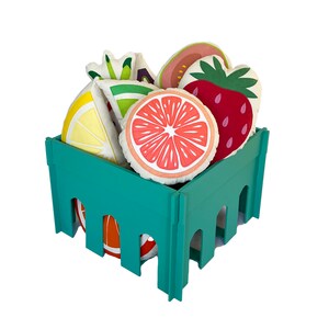 May include: A teal green crate filled with colorful fruit-shaped pillows. The pillows are shaped like a lemon, lime, grapefruit, strawberry, and guava.