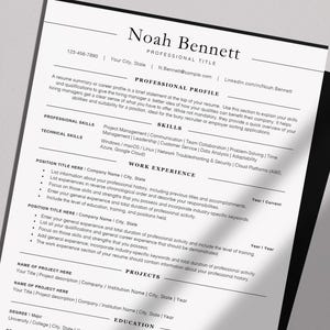 May include: A professional resume template with the name "Noah Bennett" at the top. The resume includes sections for professional profile, skills, work experience, projects, and education. The document is printed on white paper.