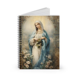 May include: A spiral bound notebook with a colorful image of a woman in a blue robe holding a bouquet of flowers. The woman is surrounded by white roses and a halo of light.