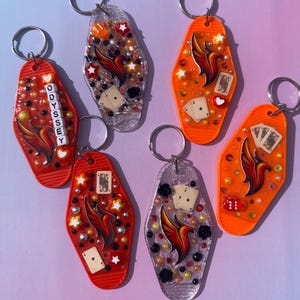 May include: A handmade wooden sign with the text "Welcome" in a playful font. The sign is painted white with black lettering and features a small, decorative heart. It's designed for indoor or outdoor use.