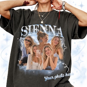 May include: A charcoal grey short-sleeve t-shirt featuring a graphic print with the text SIENNA and YOUR PHOTO HERE. The design includes a collage of four photographs of a person, surrounded by blue lightning bolts and star accents.