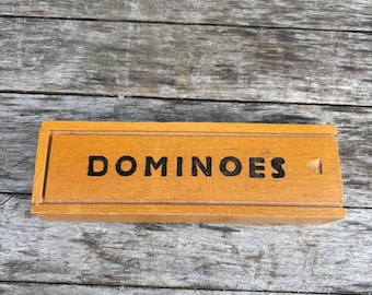 True vintage wooden dominoes in a box: imperfectly perfect, unique black hand painted dominoes, board game party.