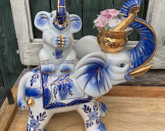 Vintage elephant trunk glazed gold hand painted porcelain with asian baby 8’’.