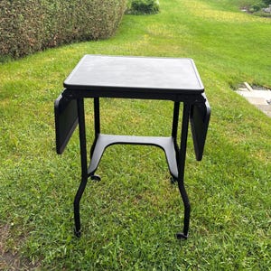 Vintage Metal typewriter table with drop leaf sides.