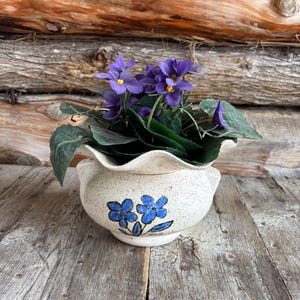 May include: A rustic wooden sign with the text "Welcome to our home" in white lettering. The sign has a distressed finish and a simple, inviting design, ideal for entryway decor.
