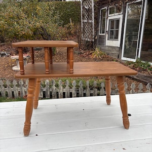Vintage 70s modern 2 tier formica table with wooden legs.