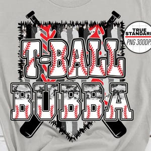 May include: Gray t-shirt with a black and white baseball graphic and the text "T-BALL BUBBA".