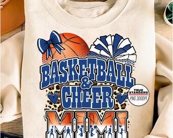 Puede incluir: Sudadera color crema con un gráfico de baloncesto y pompones. El diseño incluye las palabras "Basketball & Cheer" y "MIMI" en azul, con un fondo de estampado de leopardo. También presenta un lazo azul.