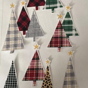 Może przedstawiać: Dziesięć filcowych ozdób choinkowych w różnych wzorach, w tym kratę, kratę, wzór lamparta i kratkę. Każda choinka ma na szczycie złotą gwiazdę.