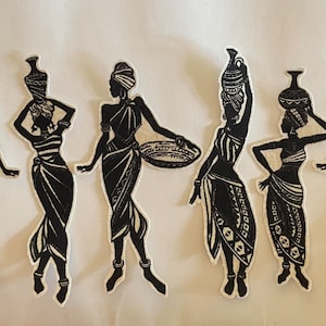May include: Six black and white silhouette patches of African women in various poses. Some carry baskets, others carry water jugs on their heads. The women are wearing head wraps and decorative clothing. The patches have a white border.