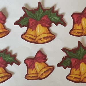 May include: Six Christmas bell patches. Each patch features two golden bells with a red bow and green holly leaves. The patches have a brown border and are arranged on a white background.