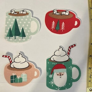 May include: Four different Christmas-themed mugs with various designs. One mug is green with white polka dots and a forest scene, another is red with a forest scene, one is pink with a gift box design, and the last is green with a snowflake pattern and a Santa Claus face.