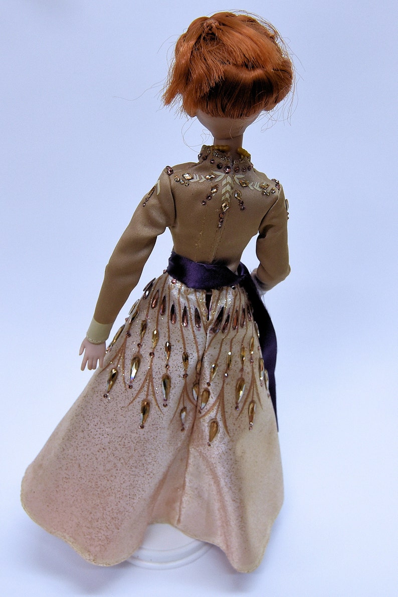 This Anna doll has a small fortune of "gems" on her gown.  The only doll that comes even close is Saks Fifth Avenue's doll with 2 stones on her gown.  My Anna doll has Crystal Rhinestones *all over* her gown---and costs 1/3 as much!